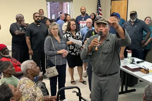 St. Rose, La., resident Marshall Dickerson, 69, urges community members opposed to the St. Charles Clean Fuels ammonia production facility to come to a public hearing rescheduled for a later date after crowds overflowed a small room in a public library, Thursday, Sept. 26, 2204, in St. Charles Parish, La. (AP Photo/Jack Brook)