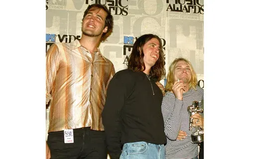 Nirvana band members, from left, Krist Novoselic, Dave Grohl and Kurt Cobain pose after receiving an award for best alternative video at the 10th annual MTV Video Music Awards in Universal City, Calif., on Sept. 2, 1993. A federal judge has dismissed the lawsuit of a 30-year-old man who alleged that the image of him nude as a baby on the 1991 cover of Nirvana’s “Nevermind" is child pornography. Judge Fernando Olguin granted the motion by Nirvana's attorneys to dismiss the case Monday, Jan. 3
