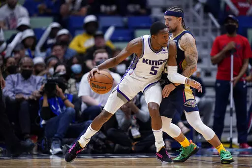 Sacramento Kings guard De'Aaron Fox (5) drives to the basket against New Orleans Pelicans guard Jose Alvarado in the second half of an NBA basketball game in New Orleans, Wednesday, March 2, 2022. The Pelicans won 125-95. (AP Photo/Gerald Herbert)