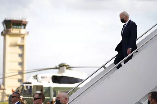 U.S. President Joe Biden, right, disembarks from Air Force One on his arrival at Yokota Air Base, Sunday, May 22, 2022, in Fussa, on the outskirt of Tokyo, Japan. (AP Photo/Evan Vucci)