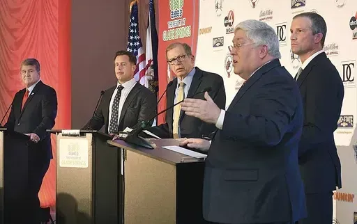 Attorney General Patrick Morrisey, in foreground, speaks as West Virginia gubernatorial candidates, from left, Mac Warner, Chris Miller, moderator and MetroNews Radio host Hoppy Kercheval and Moore Capito participate in a GOP debate held at The Resort at Glade Springs, Feb. 6, 2024, in Daniels, W.Va. When West Virginia Republicans vote in the primary on Tuesday, May 14, they will have a hard time finding a major candidate on the ballot in any statewide race who openly acknowledges that President