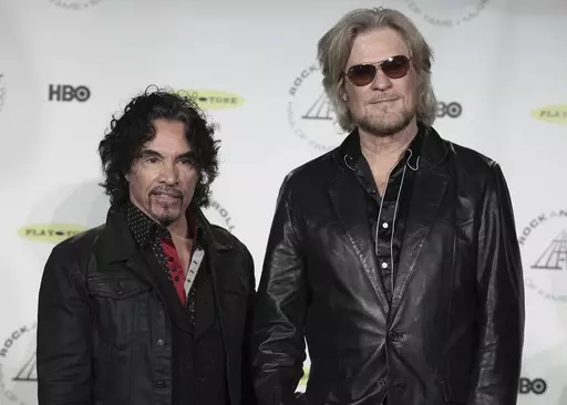 Hall of Fame Inductees, Hall & Oates, John Oates and Daryl Hall appear in the press room at the 2014 Rock and Roll Hall of Fame Induction Ceremony on April, 10, 2014, in New York. Hall has sued his longtime music partner John Oates, arguing that his plan to sell off his share of a joint venture would violate a business agreement the duo had. (Photo by Andy Kropa/Invision/AP, File)