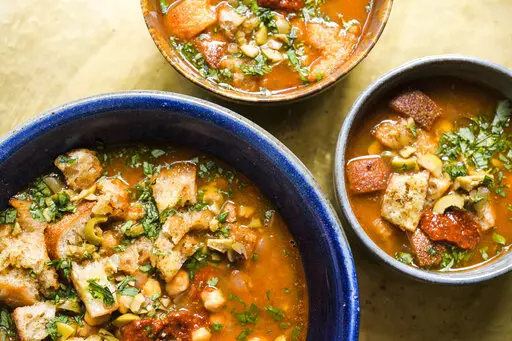 This image released by Milk Street shows a recipe for Chickpea & Harissa Soup. (Milk Street via AP)