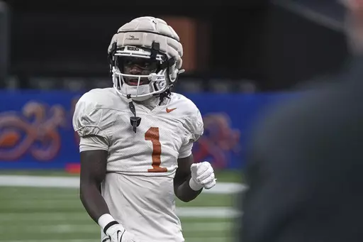 Texas wide receiver Xavier Worthy (1) walks the field during practice at the Superdome ahead of the Sugar Bowl in New Orleans, Thursday, Dec. 28, 2023. Texas will take on the Washington in the Sugar Bowl on Monday, Jan. 1, 2024. (Aaron E. Martinez /Austin American-Statesman via AP)