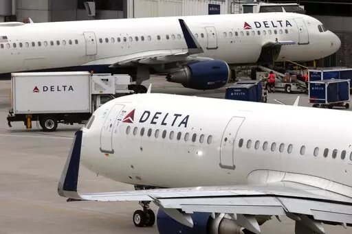 Delta Air Lines plane leaves the gate, Monday, July 12, 2021, at Logan International Airport in Boston.  Delta Air Lines has requested that the U.S. Department of Justice put any person convicted of a disruption on board a flight to the national “no fly” list. In a letter to the Justice Department Attorney General Merrick Garland dated Thursday, Feb. 3, 2022, Delta CEO Ed Bastian said there should be “zero tolerance” for any behavior that affects flight safety.  (AP Photo/Michael Dwyer)