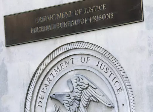 A sign for the Department of Justice Federal Bureau of Prisons is displayed at the Metropolitan Detention Center in the Brooklyn borough of New York, July 6, 2020. Oklahoma is suing the Federal Bureau of Prisons for custody of a state death row inmate who the bureau is refusing to transfer, with the state saying the man's scheduled execution cannot be carried out in December if he is not returned soon. (AP Photo/Mark Lennihan, File)