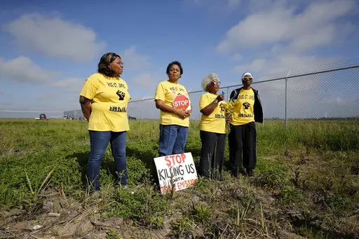Myrtle Felton, from left, Sharon Lavigne, Gail LeBoeuf and Rita Cooper conduct a live stream video on property owned by Formosa on March 11, 2020, in St. James Parish, La. Residents of a Louisiana parish located in the heart of a cluster of polluting petrochemical factories filed a federal lawsuit Tuesday, March 21, 2023, raising allegations of civil rights, environmental justice and religious liberty violations. LeBoeuf, a co-founder of Inclusive Louisiana, has liver cancer, which she acknowled