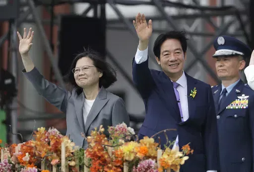 Taiwan's new President Lai Ching-te, right, and former President Tsai Ing-wen wave during Lai's inauguration ceremonies in Taipei, Taiwan, Monday, May 20, 2024. Lai in his inauguration speech has urged China to stop its military intimidation against the self-governed island Beijing claims as its own territory. (AP Photo/Chiang Ying-ying)