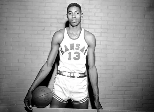 Wilt Chamberlain, Kansas' 7-foot basketball star, poses for a photo during a pause in practice in Allen Field House in Lawrence, Kan., March 1, 1957. In the 1957 NCAA college championship, North Carolina defeated Chamberlain and Kansas in triple overtime. (AP Photo/William P. Straeter, File)