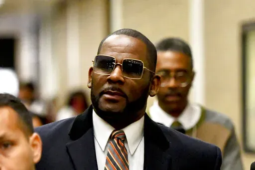 Musician R. Kelly, center, leaves the Daley Center after a hearing in his child support case on May 8, 2019, in Chicago. Closing arguments are scheduled Monday, Sept. 12, 2022 for R. Kelly and two co-defendants in the R&B singer’s trial on federal charges of trial-fixing, child pornography and enticing minors for sex, with jury deliberations to follow. (AP Photo/Matt Marton, File)