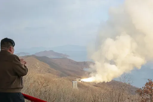In this photo provided by the North Korean government, North Korean leader Kim Jong Un, left, watches what it says a test of a solid-fuel engine for its new-type intermediate-range hypersonic missile at the Sohae Satellite Launching Ground in North Korea Tuesday, March 19, 2024. Independent journalists were not given access to cover the event depicted in this image distributed by the North Korean government. The content of this image is as provided and cannot be independently verified. (Korean C