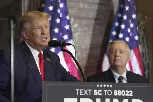 Former President Donald Trump, left, speaks at a campaign event as Sen. Lindsey Graham, R-S.C., looks on Jan. 28, 2023, in Columbia, S.C. The long and occasionally quixotic relationship between Trump and Graham has turned negative once more after the South Carolina senator criticized Trump's refusal to support a federal abortion ban. (AP Photo/Meg Kinnard, File)