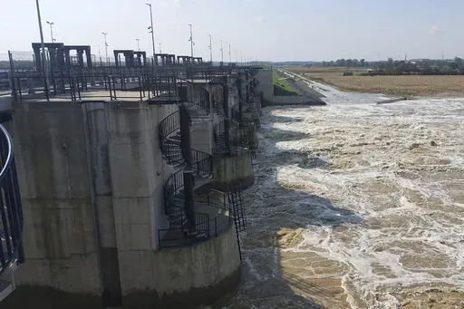 This photo provided by the state company Polish Waters shows the Oder River flood waters channelled into and contained by the newly-built Lower Raciborz Reservoir that has spared the cities of Opole and Wroclaw from flooding, in Raciborz, southwestern Poland, Sept. 23, 2024. (Polish Waters via AP)