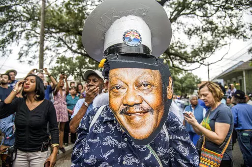 Fans parade down Poland Avenue toward the former home of music legend Antoine 'Fats' Domino during a second line parade honoring him on Nov. 1, 2017, in New Orleans. The New Orleans street where Domino, one of the founders of rock ‘n’ roll spent most of his life, is being renamed in his honor. (Photo by Amy Harris/Invision/AP, File)