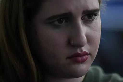 Eden Hebron, 19, talks about the years of work she has done to cope with trauma and mental health effects after witnessing a gunman kill a close friend and two other students in Florida's 2018 high school massacre in Parkland, during an interview with Associated Press journalists, Tuesday, March 8, 2022, in Hollywood, Fla. Hebron's experience shows how many of the survivors have grappled with severe mental health issues that derailed their adolescence and greatly impacted their families.(AP Phot