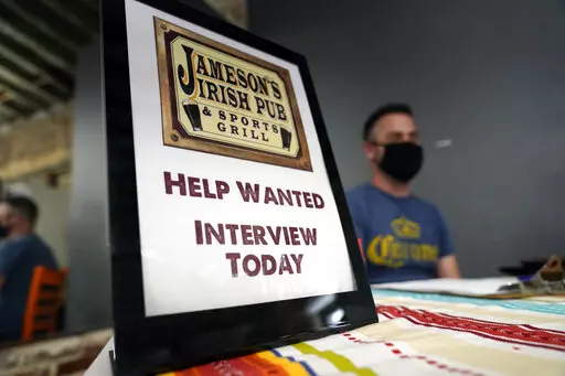A hiring sign is placed at a booth for Jameson's Irish Pub during a job fair Wednesday, Sept. 22, 2021, in the West Hollywood section of Los Angeles.  In a surprising burst of hiring, America’s employers added 467,000 jobs in January 2022 in a sign of the economy’s resilience even in the face of a wave of omicron infections last month. (AP Photo/Marcio Jose Sanchez, File)