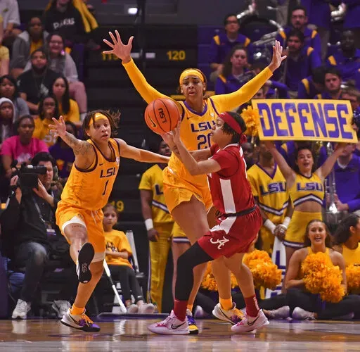 LSU guard Jailin Cherry (1) and center Hannah Gusters (20) defend against Alabama guard Megan Abrams (1) in the second half of an NCAA college basketball game Thursday, Feb. 24, 2022, in Baton Rouge, La. (Hilary Scheinuk/The Advocate via AP)