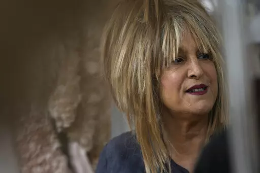 Elizabeth Emanuel, who designed Diana, Princess of Wales wedding dress, looks on at her studio during an interview with the Associated Press in Maida Vale, London, Monday, Aug. 22, 2022. (AP Photo/Alastair Grant)