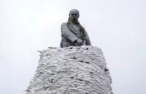 A monument of Taras Shevchenko, a Ukrainian poet and a national symbol, is covered with bags to protect it from Russian shelling in Kharkiv, Ukraine, Sunday, March 27, 2022. The bronze, 16-meter high monument was placed in 1935, survived WWII and is considered one of the world's best monuments to Shevchenko. (AP Photo/Efrem Lukatsky)