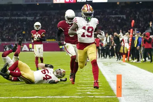 San Francisco 49ers wide receiver Deebo Samuel scores a touchdown during the second half of an NFL football game against the Arizona Cardinals, Monday, Nov. 21, 2022, in Mexico City. (AP Photo/Marcio Jose Sanchez)