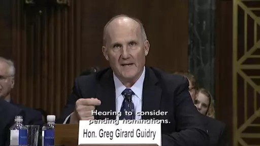 In this image from video provided by the U.S. Senate, Judge Greg Guidry speaks during a hearing for district court nominees held by the Senate Committee on the Judiciary in Washington, on Wednesday, Feb. 13, 2019. Guidry donated tens of thousands of dollars to New Orleans’ Roman Catholic archdiocese and consistently ruled in favor of the church amid a contentious bankruptcy involving nearly 500 clergy sex abuse victims, The Associated Press found, an apparent conflict that could throw the case