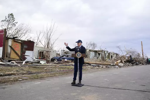 President Joe Biden speaks after surveying storm damage from tornadoes and extreme weather in Dawson Springs, Ky., Dec. 15, 2021. Biden faces a steep path to achieve his ambitious goal of slashing planet-warming greenhouse gas emissions in half by 2030. His $2 trillion Build Back Better plan contains $550 billion in spending and tax credits aimed at promoting clean energy.  (AP Photo/Andrew Harnik, File)