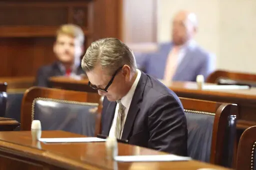 Republican South Carolina Sen. Tom Davis looks over papers at his desk before debate about a bill banning abortion on Wednesday, Sept. 7, 2022, in Columbia, S.C. (AP Photo/Jeffrey Collins)