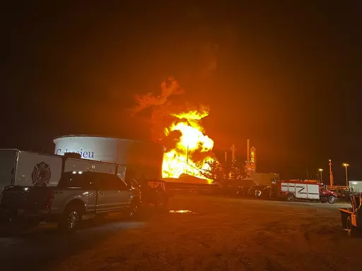 This image provided by Louisiana State Police shows a fire at a storage tank containing volatile naphthalene in Lake Charles, La., on Saturday night, June 3, 2023. The fire is believed to have been ignited by lightning as storms moved through the area earlier in the day. (Louisiana State Police via AP)