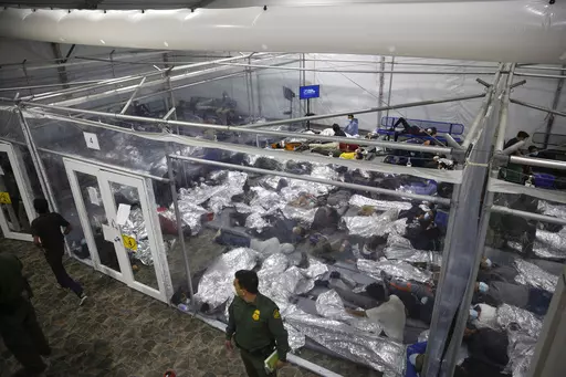 Children lie inside a pod at the main detention center for unaccompanied children in the Rio Grande Valley run by U.S. Customs and Border Protection (CBP), in Donna, Texas, March 30, 2021. A company that provides services for immigrants in federal detention was ordered Tuesday, April 2, 2024, to pay more than $811 million in restitution and penalties in a lawsuit alleging it used deceptive and abusive tactics. (AP Photo/Dario Lopez-Mills, Pool, File)
