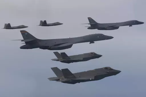 In this photo provided by South Korean Defense Ministry, U.S. Air Force B-1B bombers, center, F-22 fighter jets and South Korean Air Force F-35 fighter jets, bottom, fly over South Korea Peninsula during a joint air drill in South Korea, on Jan. 1, 2023. South Korean and U.S. militaries will hold a table-top exercise at the Pentagon next week to hone their joint response to a potential use of nuclear weapons by North Korea, Seoul officials said Friday, Feb. 17, 2023. (South Korean Defense Minist