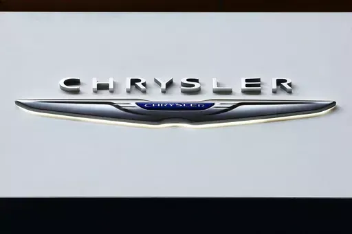 The Chrysler logo is on display at the Pittsburgh International Auto Show, Feb. 11, 2016, in Pittsburgh. On Saturday, June 8, 2024, the National Highway Traffic Safety Administration announced that Chrysler is recalling more than 211,000 SUVs and pickup trucks in the U.S., due to a software malfunction that could disable the cars' electronic stability control systems. (AP Photo/Gene J. Puskar, File)