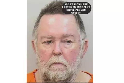 This booking photo provided by Calcasieu Parish Sheriff's Office shows David Doyle. Doyle has been charged with aggravated assault and battery after shooting at children who had been playing hide and seek outside his home, on Sunday, May 7, 2023 in Starks, La., striking a 14-year-old girl, officials said. (Calcasieu Parish Sheriff's Office via AP)
