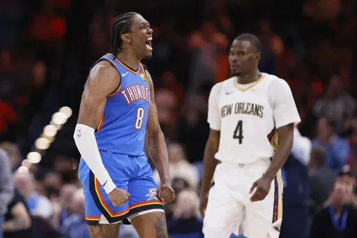 Oklahoma City Thunder forward Jalen Williams (8) celebrates near New Orleans Pelicans guard Javonte Green (4) during the second half of an NBA basketball game Wednesday, Nov. 13, 2024, in Oklahoma City. (AP Photo/Nate Billings)