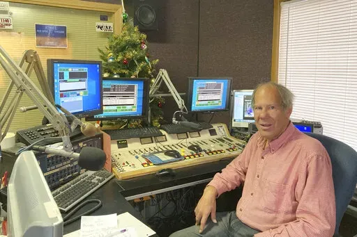 Peter Schartel, who runs a small radio company in Liberty, Mo., poses on March 17, 2022, The suburban Kansas City radio station, KCXL, is facing criticism for airing Russian state-sponsored programming in the midst of the Ukrainian war. Schartel says he is standing up for free speech and alternative viewpoints(AP Photo/Margaret Stafford)
