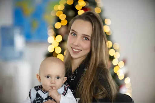 Vlada Yushchenko, a 19-year-old Ukrainian refugee, holds her son Daniel, during an interview with The Associated Press in Brasov, Romania, Thursday, Feb. 2, 2023. Yushchenko was still in her teens and nearly three months pregnant when she hugged her husband at the border, turned away and walked into Moldova. Now she’s in Romania, one of the millions of Ukrainians forced to flee Russia’s invasion of their country. Her baby, Daniel, was born there eight months ago and still hasn’t met his fa