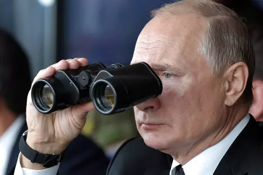 Russian President Vladimir Putin holds binoculars while watching the military exercises Center-2019 at Donguz shooting range near Orenburg, Russia, in Sept. 20, 2019. Russian President Vladimir Putin has warned that he wouldn't hesitate to use nuclear weapons to ward off Ukraine's attempt to reclaim control of its occupied regions that Moscow is about to absorb. (Alexei Nikolsky, Sputnik, Kremlin Pool Photo via AP, File)