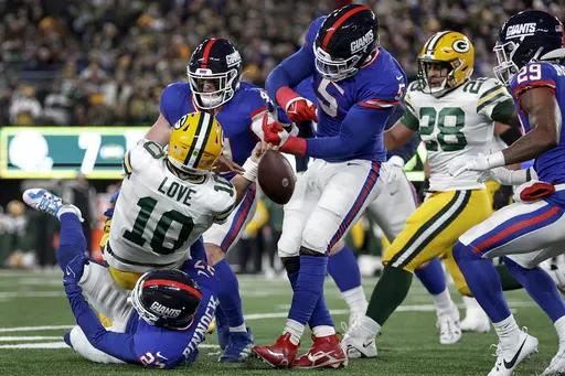 Green Bay Packers quarterback Jordan Love (10) fumbles the ball as he is tackled by New York Giants safety Jason Pinnock (27) and linebacker Kayvon Thibodeaux (5) during the second quarter of an NFL football game, Monday, Dec. 11, 2023, in East Rutherford, N.J. (AP Photo/Adam Hunger)