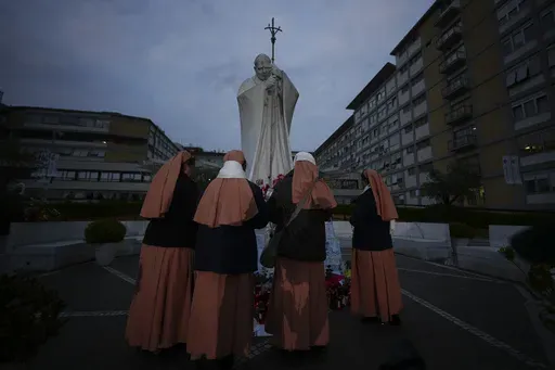 Nuns pray for Pope Francis in front of the Agostino Gemelli Polyclinic, in Rome, Saturday, March 8, 2025, where the Pontiff is hospitalized since Friday, Feb. 14. (AP Photo/Andrew Medichini)