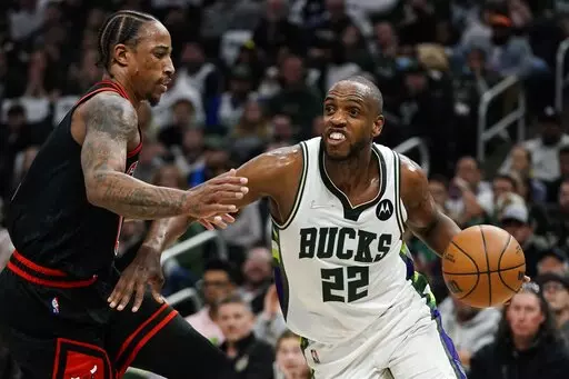 Milwaukee Bucks' Khris Middleton drives past Chicago Bulls' DeMar DeRozan during the first half of Game 1 of their first round NBA playoff basketball game Sunday, April 17, 2022, in Milwaukee. (AP Photo/Morry Gash)