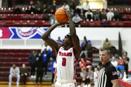 FIEL - Detroit Mercy guard Antoine Davis attempts a 3-point basket during an NCAA college basketball game against Youngstown State, Thursday, Jan. 12, 2023, in Detroit. The Detroit Mercy's star guard needs just 26 points to surpass Pete Maravich as the NCAA's career scoring leader. (AP Photo/Carlos Osorio, File)