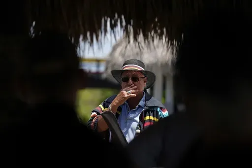 Miccosukee Tribal elder Michael Frank speaks to members of a task force that brings together federal, state, tribal and local agencies working to restore and protect the Florida Everglades, on a field visit to the Miccosukee Indian Reservation ahead of a task force meeting hosted by the Miccosukee Tribe, Wednesday, April 24, 2024. (AP Photo/Rebecca Blackwell)