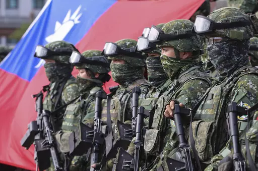Soldiers pose for group photos with a Taiwan flag after a preparedness enhancement drill simulating the defense against Beijing's military intrusions, ahead of the Lunar New Year in Kaohsiung City, Taiwan on Jan. 11, 2023. Taiwan says 103 Chinese warplanes flew toward the island in new daily high in recent times. Taiwan's Defense Ministry said that it detected the planes in the 24 hours ending at 6 a.m. Monday, Sept. 18, 2023. (AP Photo/Daniel Ceng, File)