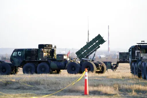 Patriot missiles are seen at the Rzeszow-Jasionka Airport, March 25, 2022, in Jasionka, Poland. The U.S. will send $1.8 billion in military aid to Ukraine in a massive package that will for the first time include a Patriot missile battery and precision guided bombs for their fighter jets, U.S. officials said Tuesday, Dec. 20, 2022, as the Biden administration prepares to welcome Ukrainian President Volodymyr Zelenskyy to Washington. (AP Photo/Evan Vucci, File)