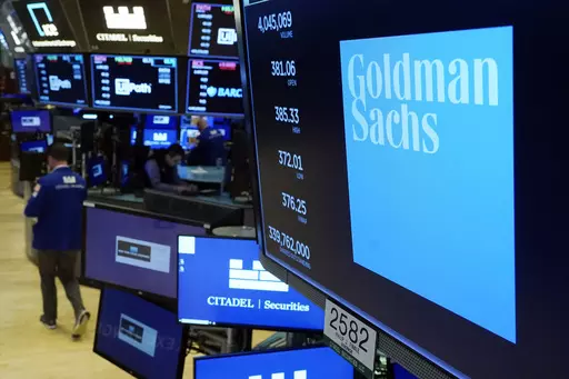 The logo for Goldman Sachs appears above a trading post on the floor of the New York Stock Exchange on July 13, 2021. Goldman Sachs has agreed Monday, May 8, 2023, to pay $215 million to settle a years-long class action lawsuit that claimed the bank discriminated against women when it came to pay, performance evaluations and promotions. (AP Photo/Richard Drew, File)