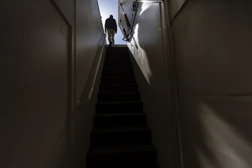 The owner, who asked not to be identified because of concerns about his privacy, walks up the steps of his underground shelter in an undisclosed Southern California city, on Dec. 16, 2024. (AP Photo/Jae C. Hong)