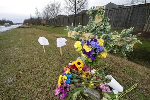 A foliage-draped cross, flowers and signs with the writing washed away by rain mark a spot on Burbank Drive near where Madison Brooks, the 19-year-old LSU sophomore who was allegedly raped in the back of a car before being dropped off in a nearby neighborhood, was fatally struck by a car on Burbank Drive about an hour later, around 2:50 a.m. on Jan. 15, 2023, authorities said. She had been drinking at Reggie's bar in Baton Rouge, La., before the incident, and deputies said Brooks had a blood-alc