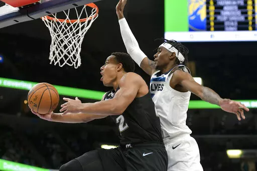 Memphis Grizzlies guard Desmond Bane (22) shoots against Minnesota Timberwolves forward Jaden McDaniels during the second half of an NBA basketball game Friday, Nov. 11, 2022, in Memphis, Tenn. (AP Photo/Brandon Dill)