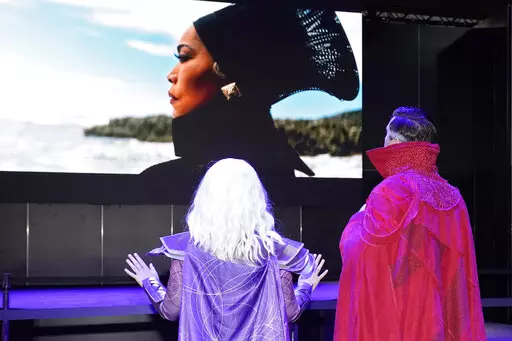 Cosplayers watch a Black Panther: Wakanda Forever trailer at the Marvel Comics exhibit at the D23 Expo Saturday, Sept. 10, 2022, in Anaheim, Calif. (AP Photo/Mark J. Terrill)