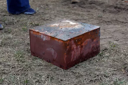 Workers recover a box believed to be the 1887 time capsule that was put under Confederate Gen. Robert E. Lee's statue pedestal in Richmond, Va., Monday, Dec. 27, 2021. Crews wrapping up the removal Monday of the giant pedestal that once held a statue of Confederate Gen. Lee found what appeared to be a second and long-sought-after time capsule, Virginia Gov. Ralph Northam said. (Eva Russo/Richmond Times-Dispatch via AP)
