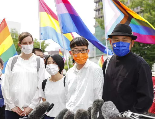 Plaintiffs speak to journalists after a court ruling in Osaka, western Japan Monday, June 20, 2022. The Osaka District Court ruled Monday that the country’s ban on same-sex marriage does not violate the constitution, and rejected demands for compensation by three couples who said their right to free union and equality has been violated. (Kyodo News via AP)